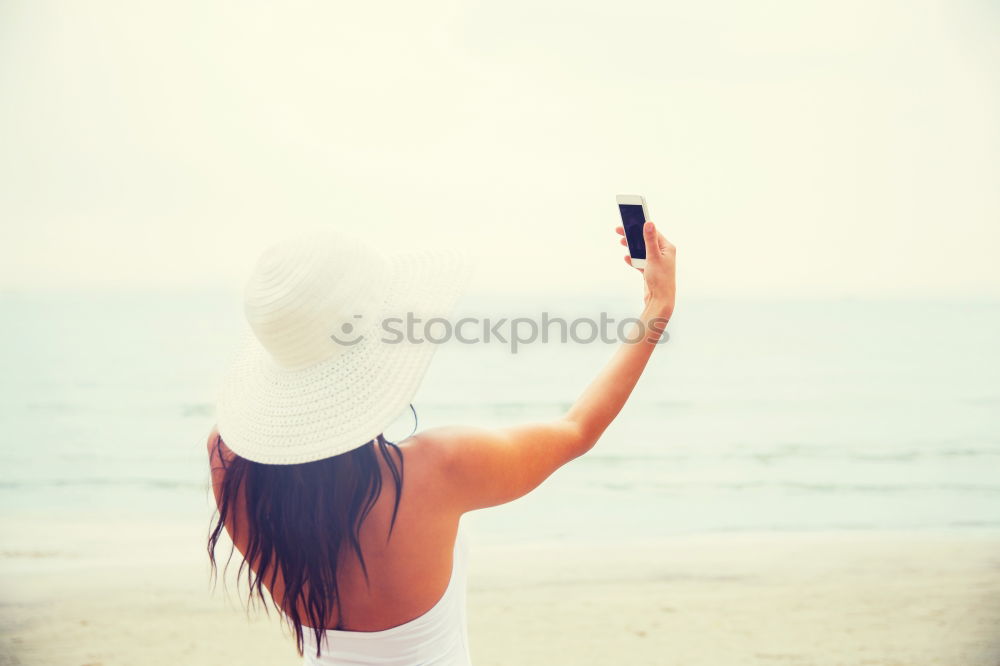 Similar – Smiling woman with sunglasses and hat raising arms happy with the sea in the background.