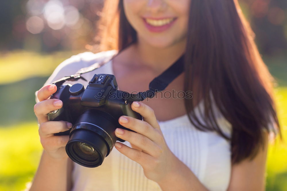 Similar – Close up of a photographer with her camera.