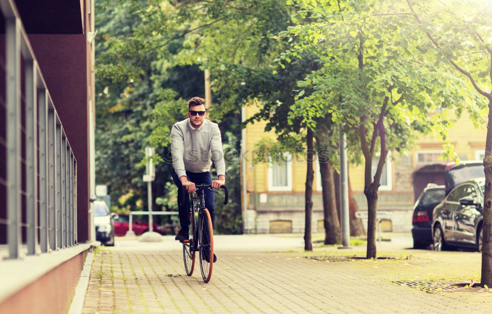 Similar – A young stylish man posing next to his bicycle.