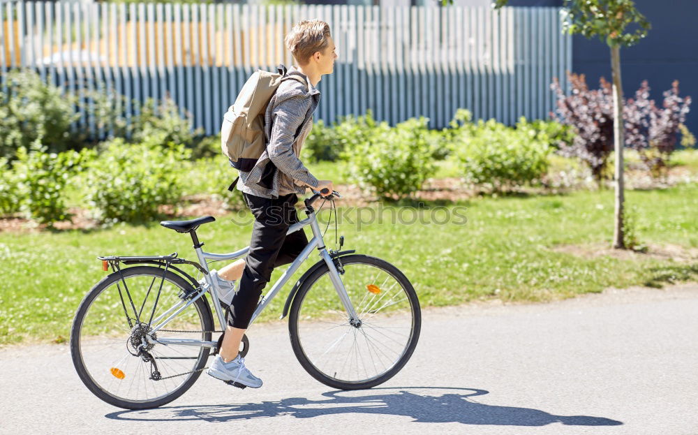 Image, Stock Photo A man pumps up the tire on his bicycle with a bicycle pump