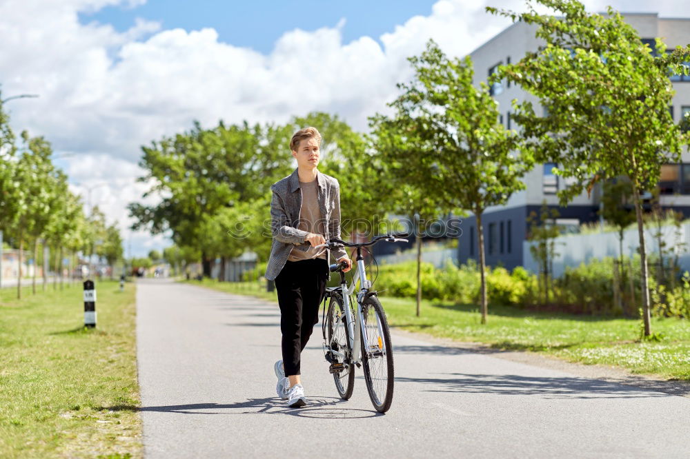 Similar – Happy family with a child riding bicycles by the city