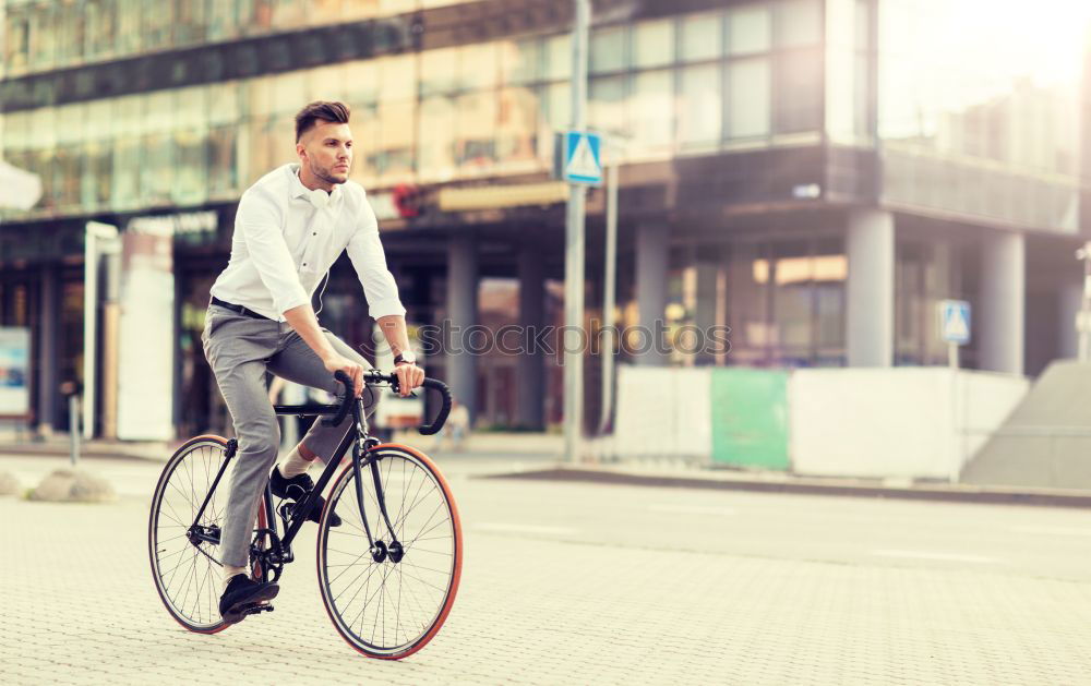 Similar – A young stylish man posing next to his bicycle.