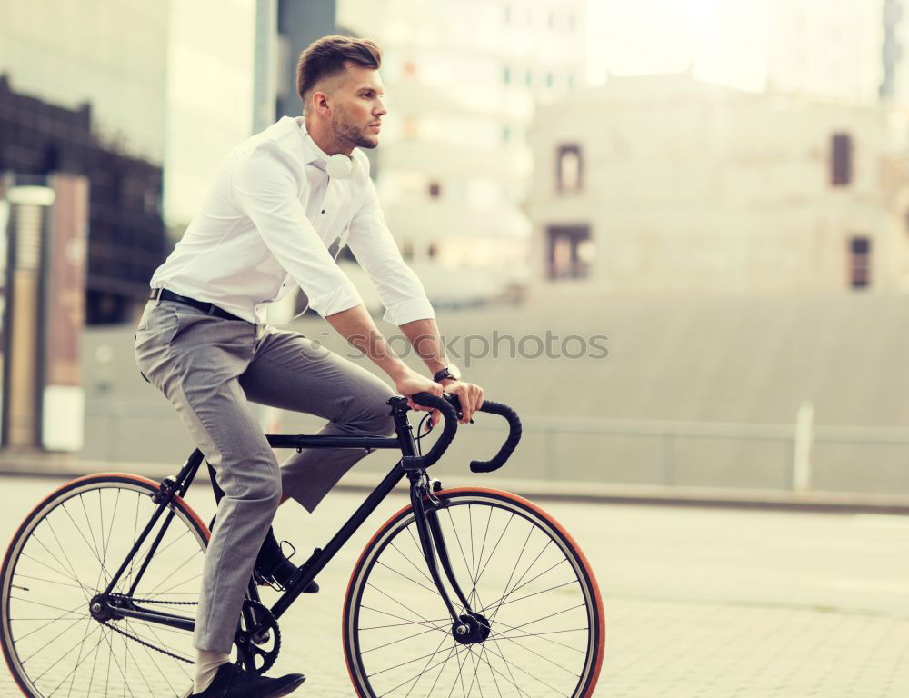 Similar – A young stylish man posing next to his bicycle.