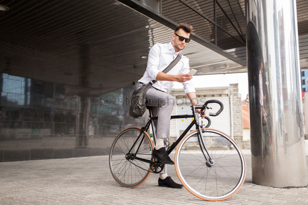 Similar – Mann mit Fahrrad auf Brücke stehend