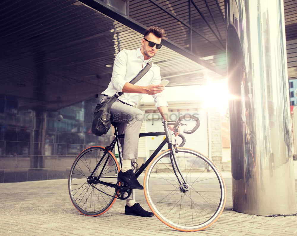 Similar – Image, Stock Photo Young man with mobile phone and fixed gear bicycle.