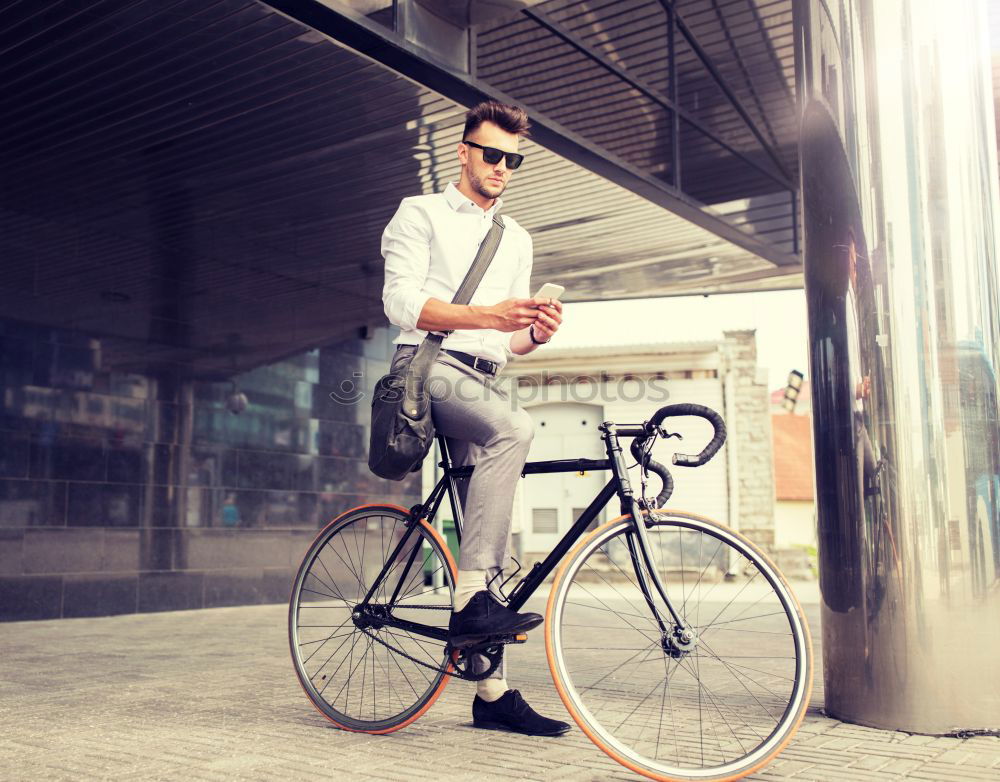 Similar – Image, Stock Photo Young man with mobile phone and fixed gear bicycle.