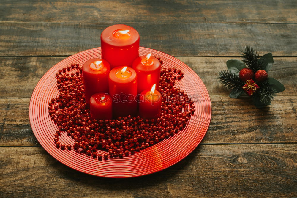 Similar – Lighted candles with red colored pearls around