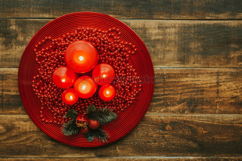 Similar – Lighted candles with red colored pearls around