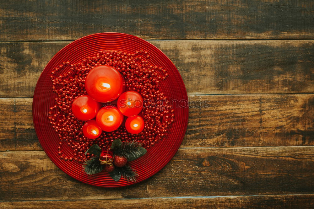 Similar – Lighted candles with red colored pearls around