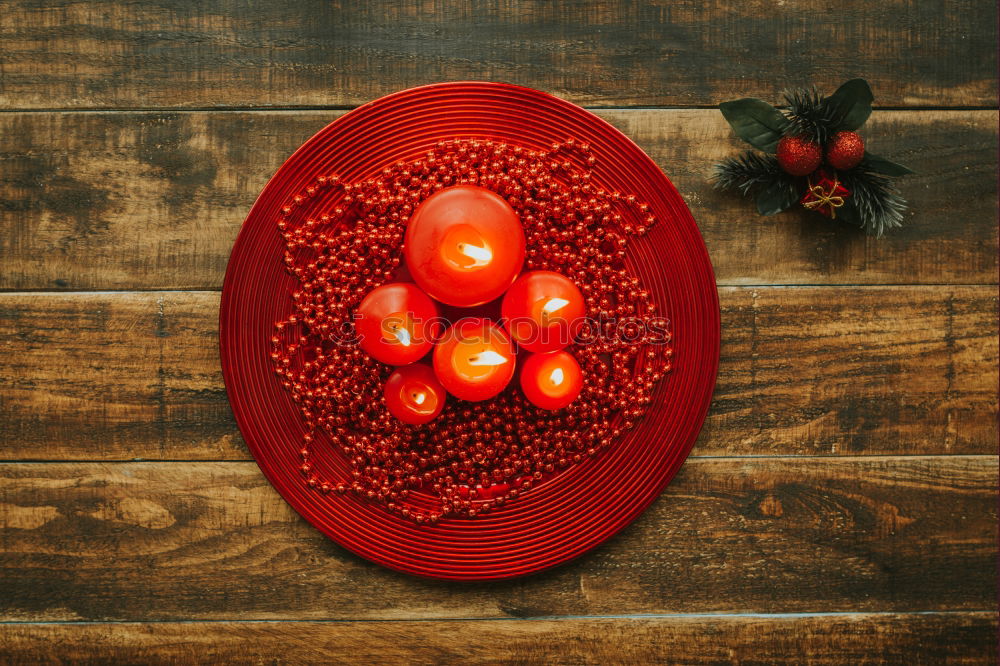 Similar – Lighted candles with red colored pearls around