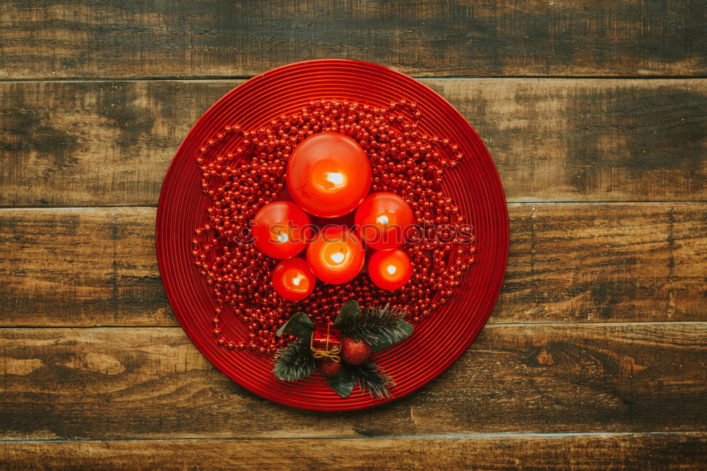 Similar – Lighted candles with red colored pearls around