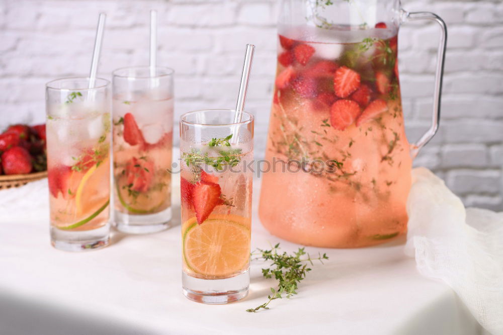 Similar – Two glasses of soft drink with honey- and watermelon, rosemary, ice cubes and drinking straw