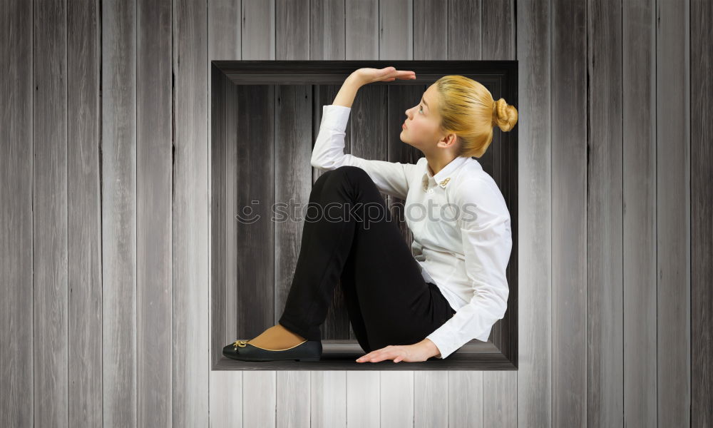 Analog portrait (35mm) of a young, slim, athletic woman sitting on a couch in her underwear and looking at the camera