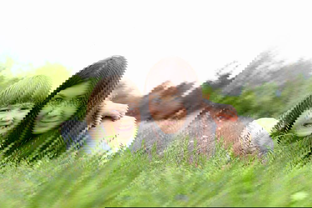 Similar – Image, Stock Photo Young mother forms heart with her children in the high grass