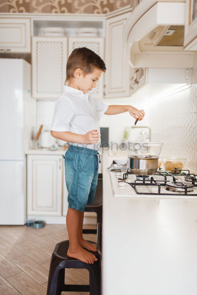 Similar – Boy in cook hat in kitchen