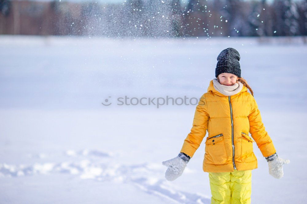 Similar – Little girl enjoying winter removing snow from a bench