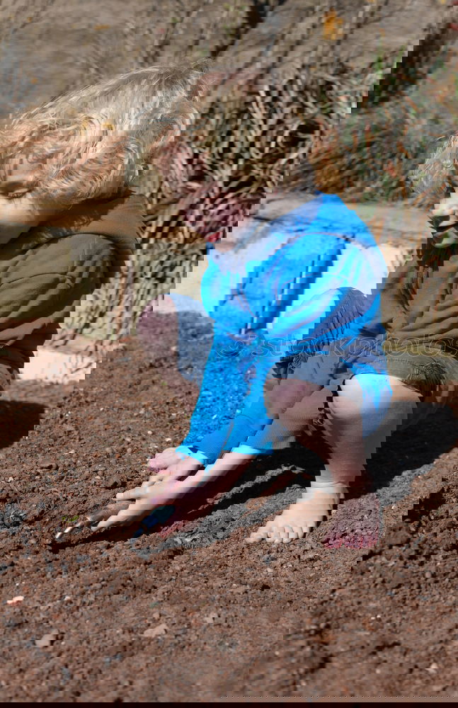 Similar – Image, Stock Photo little boy points to the path where he has discovered something