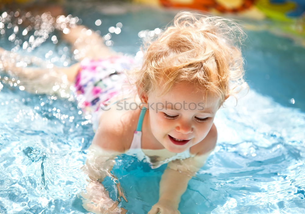 Similar – Image, Stock Photo Young boy in inflatable tube swimming with a big smile on his face