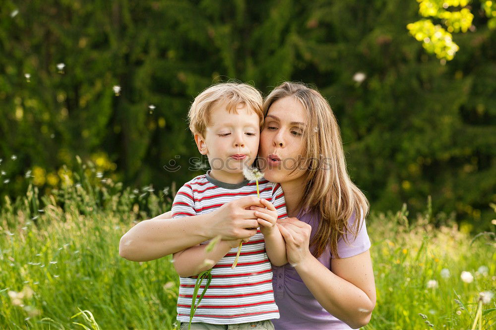 Similar – Image, Stock Photo Mother holding kid on hands in park