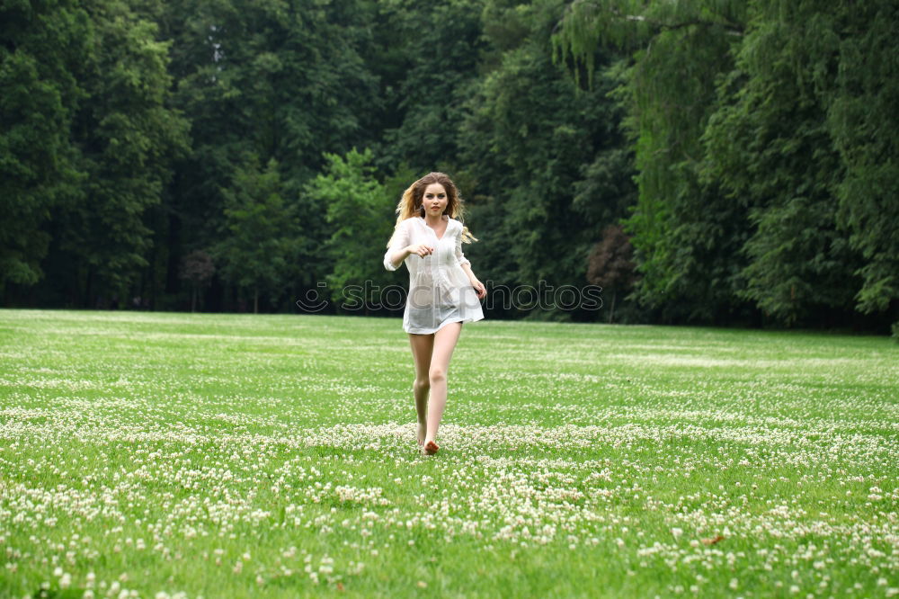 Similar – Image, Stock Photo Young, very athletic woman in skirt and t-shirt sits barefoot on a wooden bench in the forest with her legs crossed