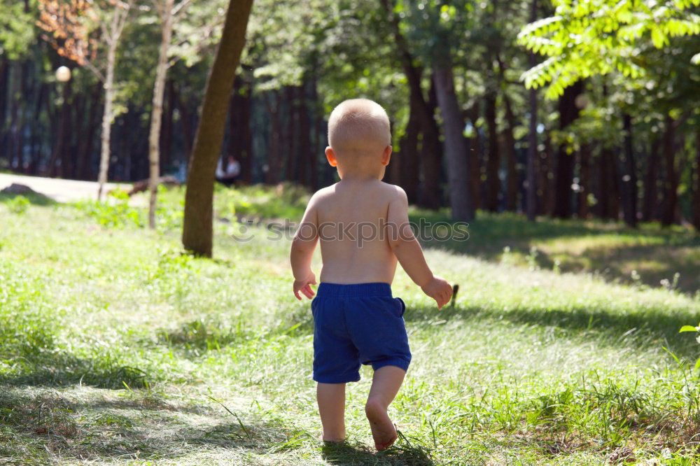 Similar – Foto Bild Junge in Gummistiefel sitzt auf Baumstamm in der Natur