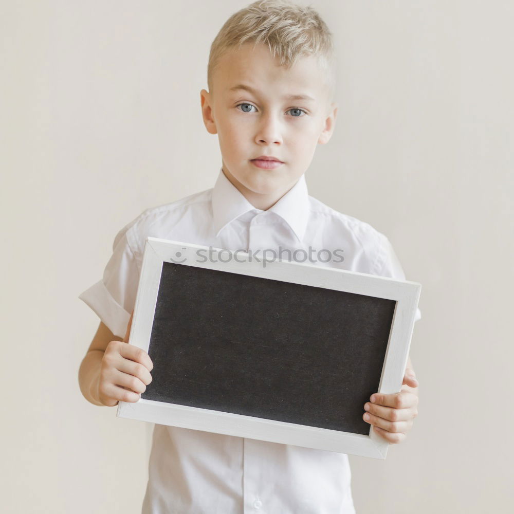 Image, Stock Photo smiling child holding a blackboard