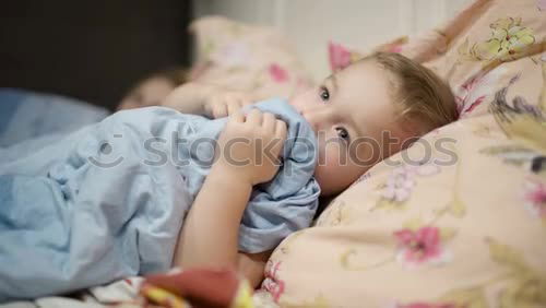 Similar – Little girl lying in a bed with teddy bear at the morning