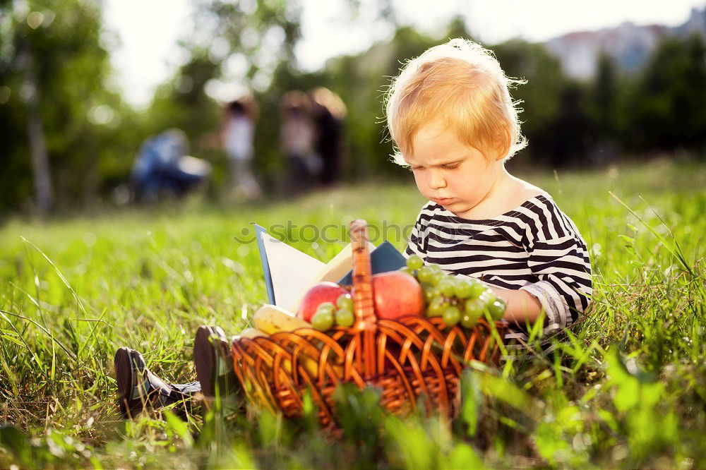 Similar – Image, Stock Photo Little baby girl watching a book with pictures