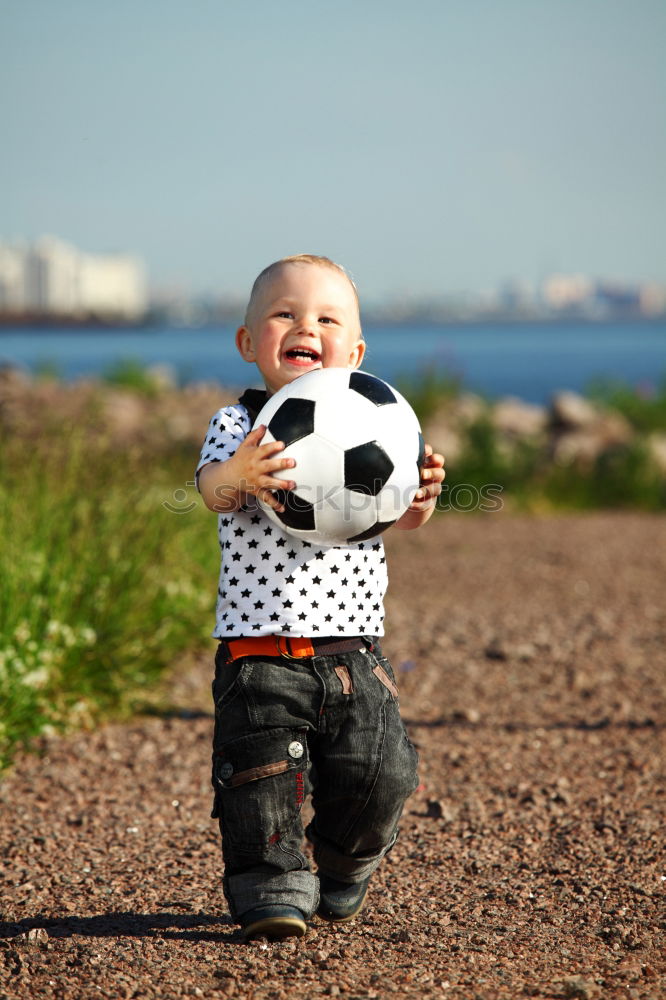 Similar – Image, Stock Photo child plays soccer with a ball