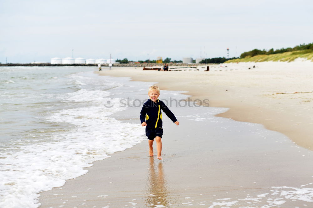 Similar – Image, Stock Photo Woman plays ball throwing with blond Labrador at Baltic Sea beach