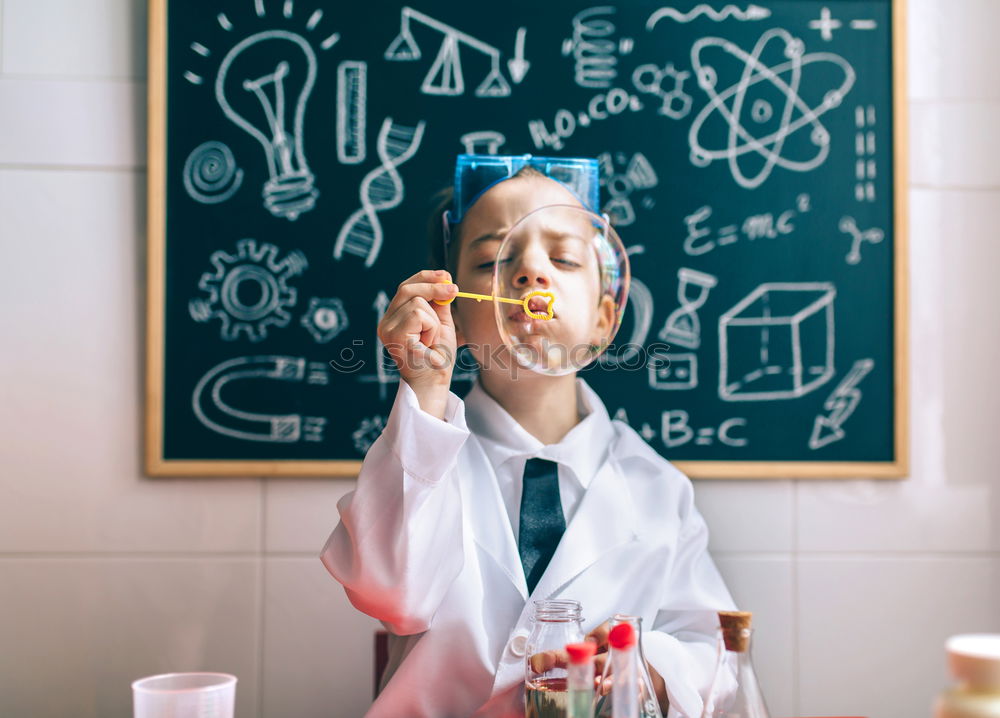 Similar – Image, Stock Photo Boy dressed as chemist with dirty face after doing an experiment