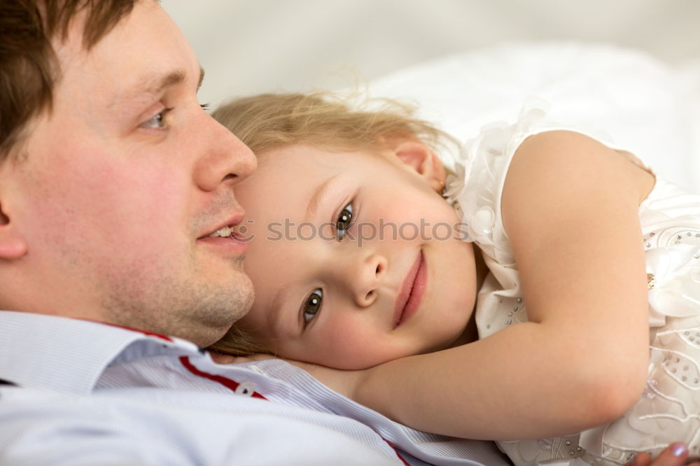 Similar – Father and daughter playing at home. Little girl closing dads eyes with hands and laughing. Family fun together