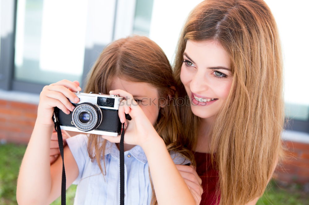 happy mother and daughter making selfie outdoor