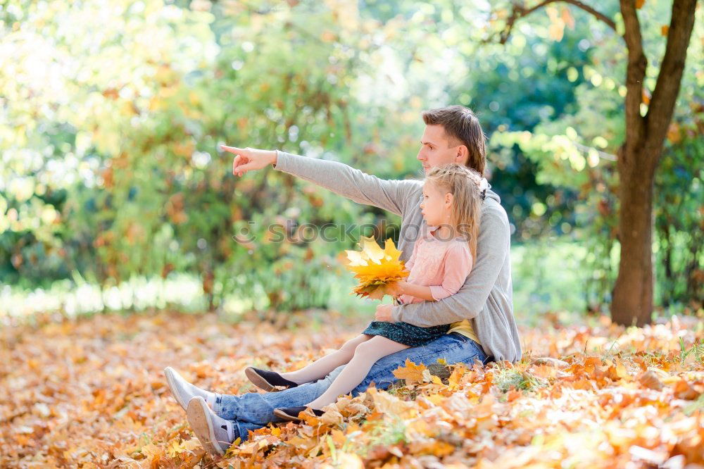 Similar – Couple makes a leaf fight in autumn