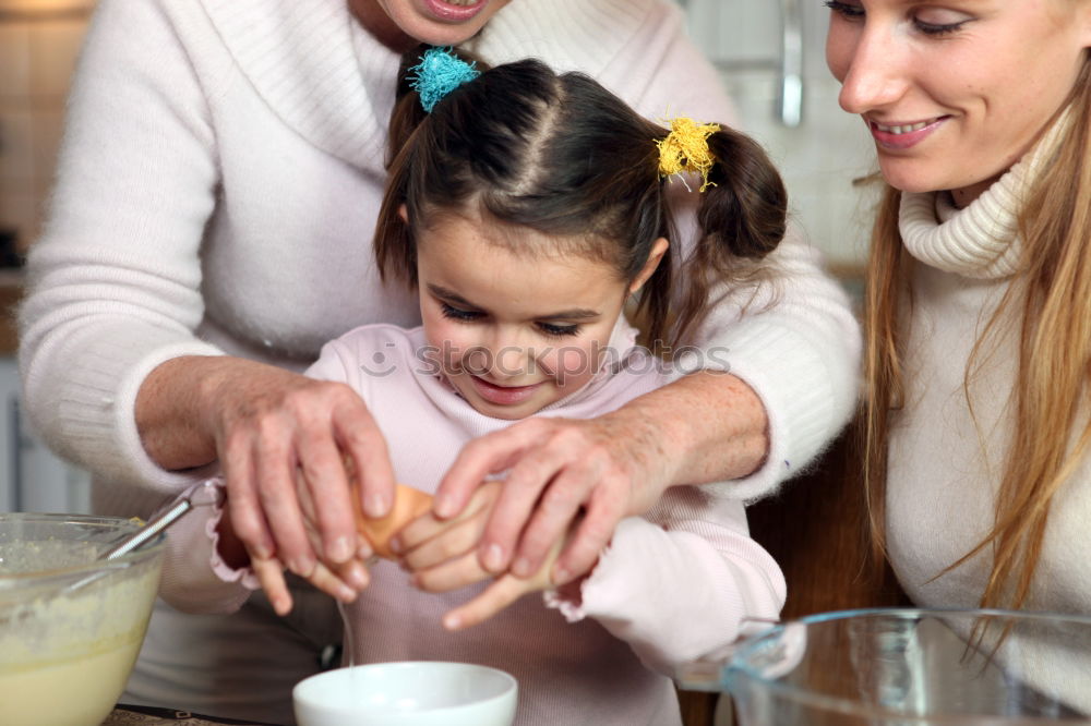 Similar – Image, Stock Photo Little sisters cooking with her mother in the kitchen.