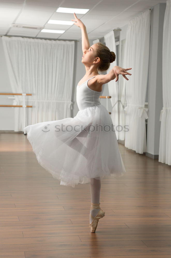 Similar – Top view at ballet dancer tying slippers around her ankle