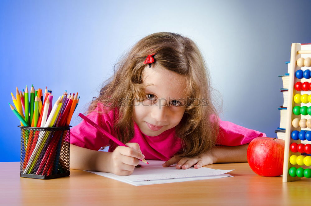 Similar – Thoughtful girl writing in class