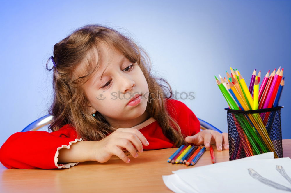 Similar – Thoughtful girl writing in class