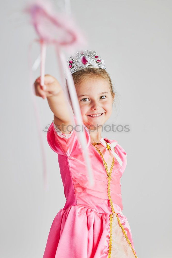 Similar – Little girl enjoying her role of princess. Adorable cute 5-6 years old girl wearing pink princess dress and tiara