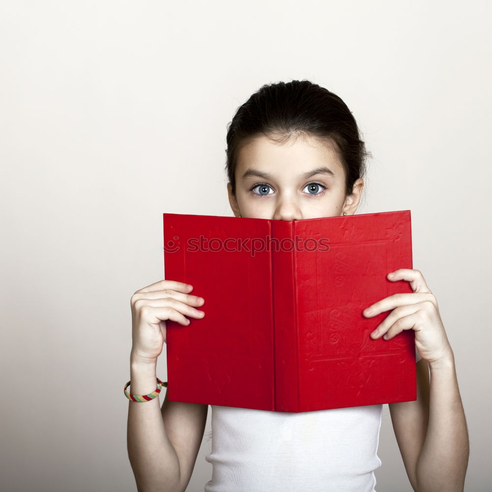 Similar – Image, Stock Photo Young girl turning the pages of book in bookstore