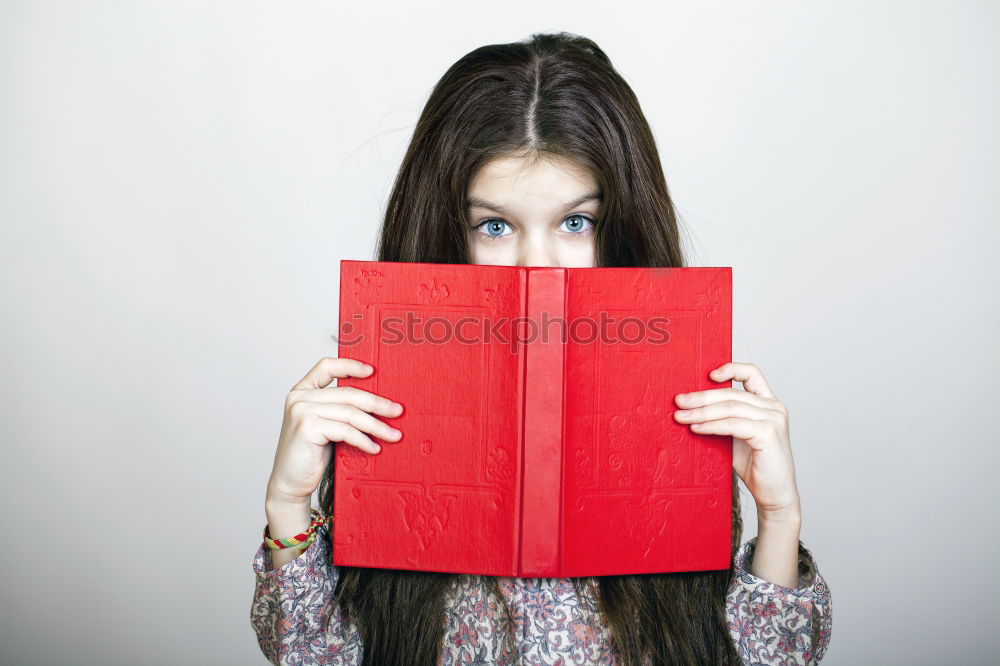 Similar – Image, Stock Photo Young girl turning the pages of book in bookstore