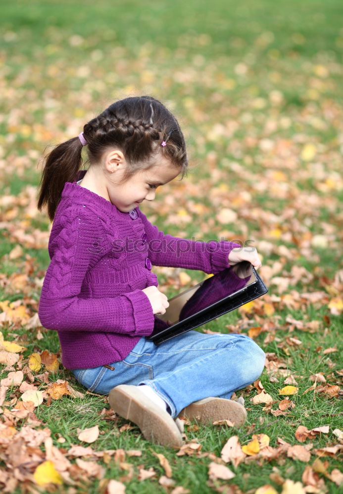 Similar – Image, Stock Photo Little baby girl watching a book with pictures