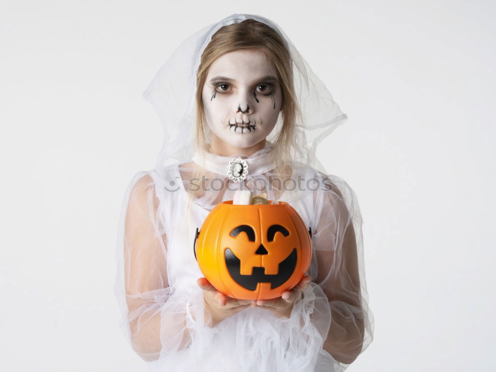 Similar – Image, Stock Photo Happy children disguised decorating a pumpkin at home.