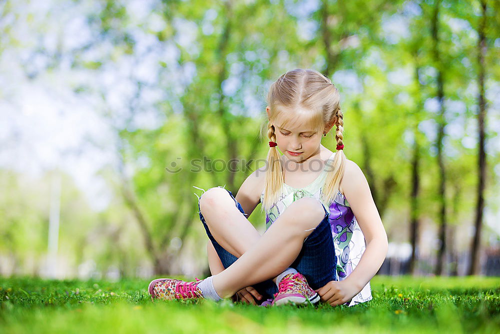 Similar – Happy little girl is smiling and  swinging  in the garden in a sunny summer day.