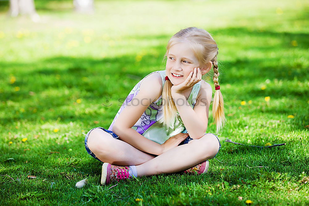 Similar – Happy little girl is smiling and  swinging  in the garden in a sunny summer day.