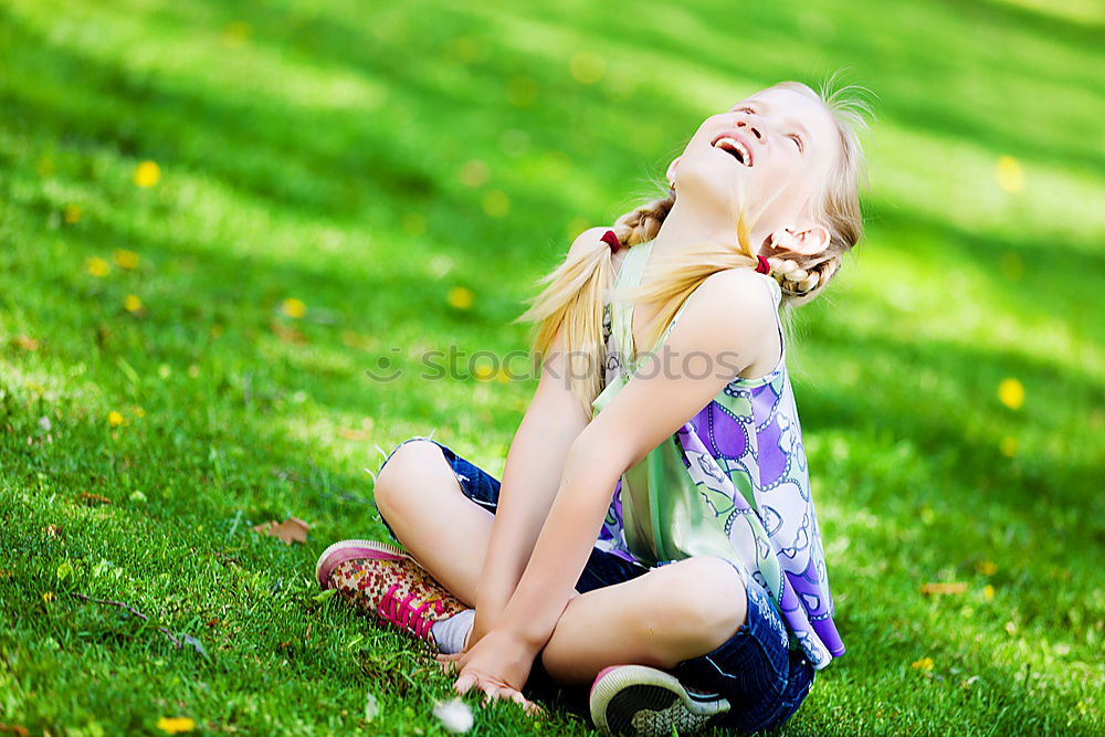 Similar – Happy little girl is smiling and  swinging  in the garden in a sunny summer day.