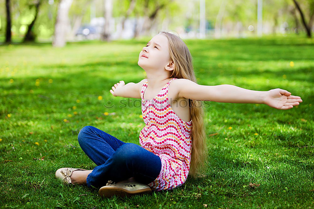 Similar – Happy little girl is smiling and  swinging  in the garden in a sunny summer day.