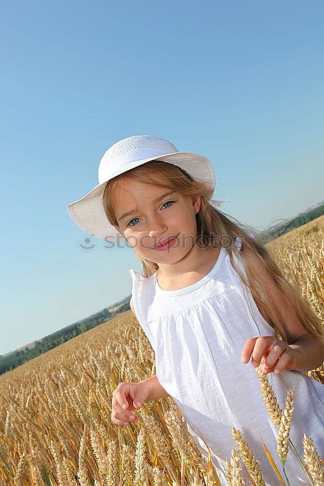 Similar – Image, Stock Photo smiling little girl holding wheat in hands