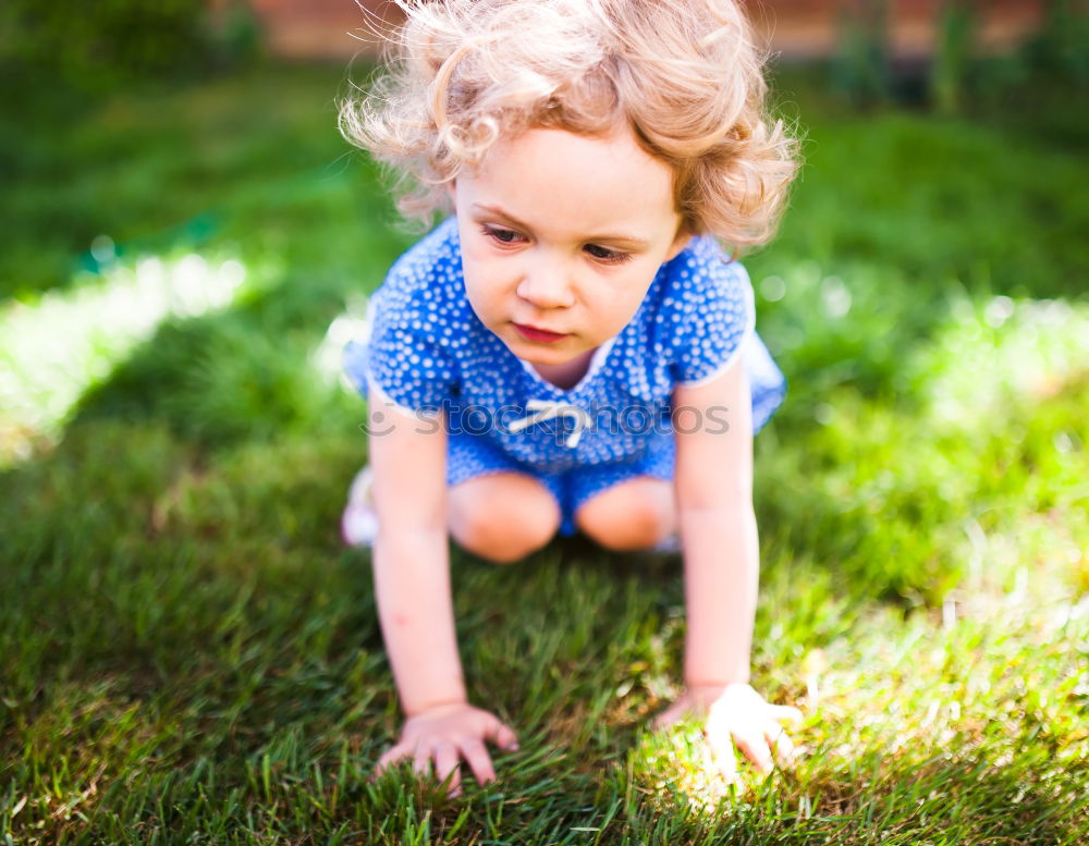 Girl climbs on boulder