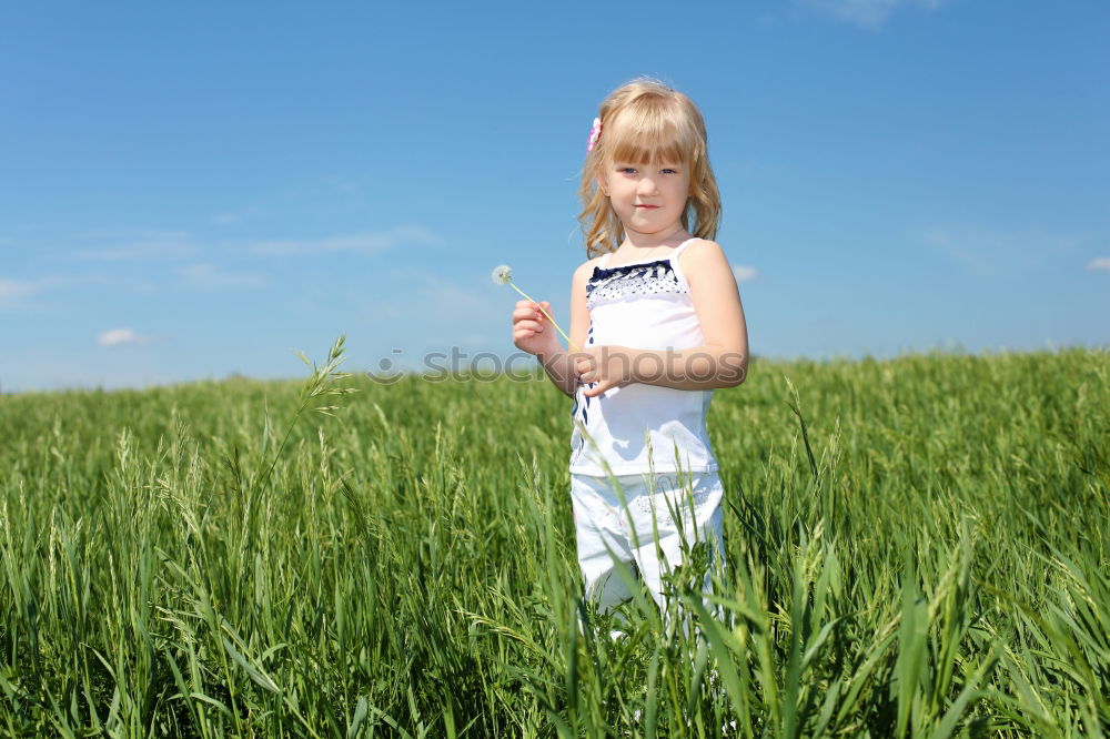 Similar – Image, Stock Photo Portrait of a young, tattooed woman sitting barefoot in a summer dress in a field